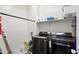 Practical laundry room equipped with modern washer and dryer units and ample shelving at 2120 N Heritage St, Buckeye, AZ 85396