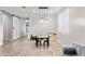 Open-concept living space featuring a modern light fixture and an adjacent staircase at 2120 N Heritage St, Buckeye, AZ 85396