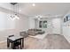 Spacious living room with stylish tile flooring and modern light fixtures at 2120 N Heritage St, Buckeye, AZ 85396