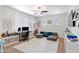 Versatile loft area with a desk, modular seating, shelving, and a ceiling fan at 2120 N Heritage St, Buckeye, AZ 85396