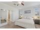 Bright main bedroom features ceiling fan, picture window, and ensuite bathroom at 2120 N Heritage St, Buckeye, AZ 85396