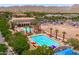 Aerial view of a community pool area with a lap pool, lounging pool, and ample seating at 2120 N Heritage St, Buckeye, AZ 85396