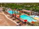 Aerial view of the neighborhood pools with festive decorations, surrounded by palm trees at 2120 N Heritage St, Buckeye, AZ 85396