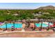 Aerial view of the neighborhood pools with festive decorations, surrounded by palm trees at 2120 N Heritage St, Buckeye, AZ 85396