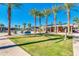 Community pool and lounging area with green grass and mature trees provides a serene setting at 2120 N Heritage St, Buckeye, AZ 85396