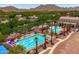 Aerial view of the neighborhood pools with festive decorations, surrounded by palm trees at 2120 N Heritage St, Buckeye, AZ 85396