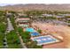 Aerial view of the neighborhood pool and clubhouse, with a blue community basketball court visible at 2120 N Heritage St, Buckeye, AZ 85396