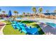 Poolside lounging with blue chairs on artificial turf at a community pool with palm trees at 2120 N Heritage St, Buckeye, AZ 85396