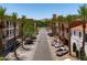 Charming street adorned with palm trees and sidewalks leading to various stores and businesses at 2120 N Heritage St, Buckeye, AZ 85396
