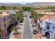 Palm-lined street with sidewalks leads to a charming shopping district, featuring well-maintained storefronts at 2120 N Heritage St, Buckeye, AZ 85396