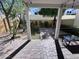 Charming covered back patio with brick paving, outdoor seating, and lush landscaping at 2339 E Evans Dr, Phoenix, AZ 85022