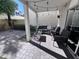 Cozy covered back patio with brick paving, outdoor seating, string lights, and privacy wall at 2339 E Evans Dr, Phoenix, AZ 85022