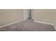 A carpeted bedroom with neutral-toned walls has a door and baseboard trim, creating a cozy feel at 240 W Juniper Ave # 1211, Gilbert, AZ 85233
