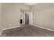 A spacious bedroom with neutral walls and carpet leads to an ensuite bathroom and additional room at 240 W Juniper Ave # 1211, Gilbert, AZ 85233
