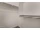 A bright, walk-in closet has ample shelving, and provides functional storage for clothes and accessories at 240 W Juniper Ave # 1211, Gilbert, AZ 85233