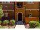 Multi-story townhome with an arched doorway, exterior number, and low-maintenance landscaping at 240 W Juniper Ave # 1211, Gilbert, AZ 85233