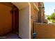 Exterior view featuring an arched entry of a multi-story townhome with a landscaped walkway at 240 W Juniper Ave # 1211, Gilbert, AZ 85233