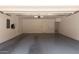 Spacious two-car garage with epoxy flooring, white walls, and a door leading to the house at 240 W Juniper Ave # 1211, Gilbert, AZ 85233