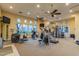 Well-equipped gym with modern machines, ceiling fans, wall-mounted TVs, and plenty of natural light from several large windows at 240 W Juniper Ave # 1211, Gilbert, AZ 85233