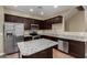 The kitchen features dark cabinetry, stainless steel appliances, and granite countertops, creating a modern look at 240 W Juniper Ave # 1211, Gilbert, AZ 85233
