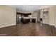 Open-concept kitchen and dining area with dark cabinets, granite countertops, and stainless steel appliances at 240 W Juniper Ave # 1211, Gilbert, AZ 85233