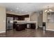 Modern kitchen with stainless steel appliances, dark cabinetry, granite countertops, and wood-look tile flooring at 240 W Juniper Ave # 1211, Gilbert, AZ 85233