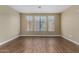 Spacious, light-filled living room featuring three windows and wood-look tile flooring at 240 W Juniper Ave # 1211, Gilbert, AZ 85233