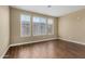 Well-lit living room showcasing beautiful wood-look tile flooring and neutral wall paint at 240 W Juniper Ave # 1211, Gilbert, AZ 85233