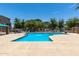 Large community swimming pool with several lounge chairs, lush greenery and trees throughout property at 240 W Juniper Ave # 1211, Gilbert, AZ 85233
