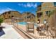 Community swimming pool and patio area with seating and a metal fence near well-maintained buildings at 240 W Juniper Ave # 1211, Gilbert, AZ 85233