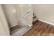 Carpeted staircase featuring a white handrail and wood-look tile flooring at the bottom landing at 240 W Juniper Ave # 1211, Gilbert, AZ 85233
