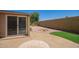 Backyard with decorative gravel, patio space and privacy wall at 2529 N Barber Dr, Mesa, AZ 85215