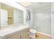 Bright bathroom featuring a shower, vanity, mirror, and toilet at 2529 N Barber Dr, Mesa, AZ 85215