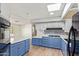 Bright eat-in kitchen featuring blue cabinets, modern appliances, and marble countertops at 2529 N Barber Dr, Mesa, AZ 85215
