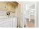 A convenient laundry room with a washer, dryer, and storage cabinets above at 2529 N Barber Dr, Mesa, AZ 85215