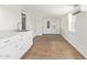 Bright living space with white walls, wood-look floors and a minimalist kitchen area at 2529 N Barber Dr, Mesa, AZ 85215