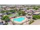 Aerial view of a community pool with lounge chairs surrounded by well maintained homes at 2790 S Alpine Dr, Gilbert, AZ 85295