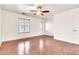 This bedroom has wood-look floors, a ceiling fan, and bright windows at 2790 S Alpine Dr, Gilbert, AZ 85295