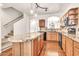 Open kitchen features wood cabinets, granite counters, black appliances, and island at 2790 S Alpine Dr, Gilbert, AZ 85295