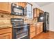 Close-up of the kitchen with black appliances, granite countertops, and wood cabinets at 2790 S Alpine Dr, Gilbert, AZ 85295