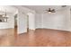 Open living room with wood-look floors, arched doorways, and neutral paint at 2790 S Alpine Dr, Gilbert, AZ 85295