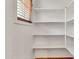 Pantry with multiple white shelves for storage and a small window with wooden blinds at 2790 S Alpine Dr, Gilbert, AZ 85295