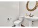 Powder room featuring a pedestal sink, circular mirror, and tiled flooring at 2790 S Alpine Dr, Gilbert, AZ 85295