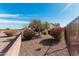 Private backyard featuring colorful landscaping and an outdoor seating area at 28798 N 127Th Ave, Peoria, AZ 85383