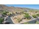 Aerial view of a home surrounded by desert landscape with mountains in the background at 3441 E Melody Dr, Phoenix, AZ 85042