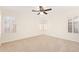 Large bedroom with neutral carpet and windows with plantation shutters at 3441 E Melody Dr, Phoenix, AZ 85042