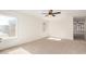 Bright, carpeted bedroom with neutral walls, a ceiling fan, and a large window, creating a serene space at 3441 E Melody Dr, Phoenix, AZ 85042
