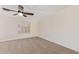 Bright, carpeted bedroom with a ceiling fan and plantation shutters for added privacy and style at 3441 E Melody Dr, Phoenix, AZ 85042