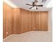Cozy den features unique wood paneling and carpet, creating a warm and inviting atmosphere at 3441 E Melody Dr, Phoenix, AZ 85042