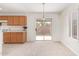 Bright dining area features a sliding glass door to the backyard and neutral carpet at 3441 E Melody Dr, Phoenix, AZ 85042
